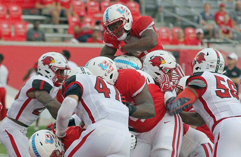 HOUSTON, TX - SEPTEMBER 10: Running back Mulbah Car #34 of the Houston Cougars goes over the...