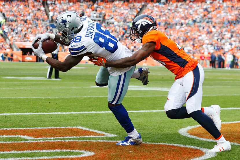 Dallas Cowboys wide receiver Dez Bryant (88) catches a pass in front of Denver Broncos...