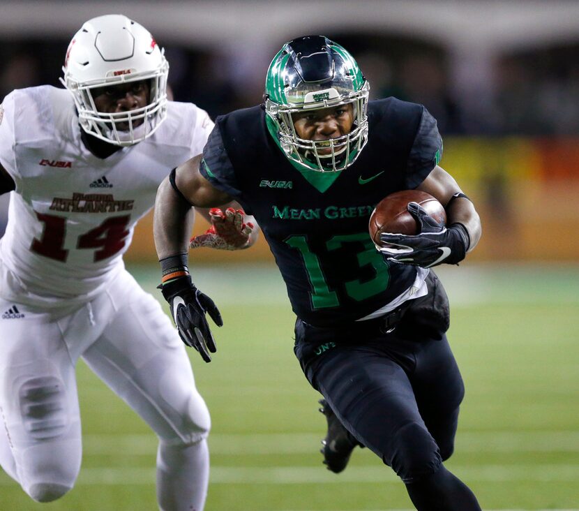 North Texas Mean Green running back DeAndre Torrey (13) races around the ned past Florida...