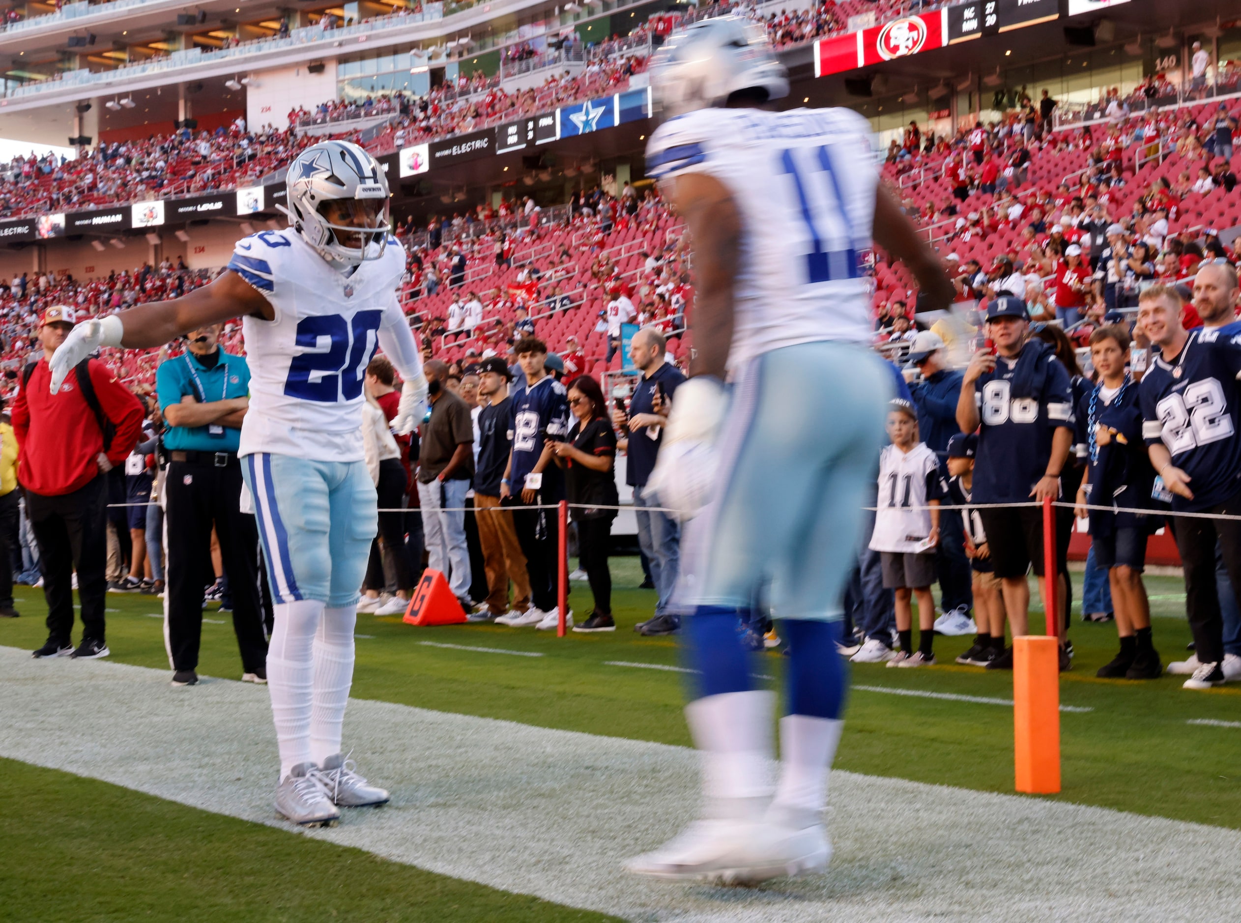 Dallas Cowboys running back Tony Pollard (20) greets linebacker Micah Parsons (11) as the...