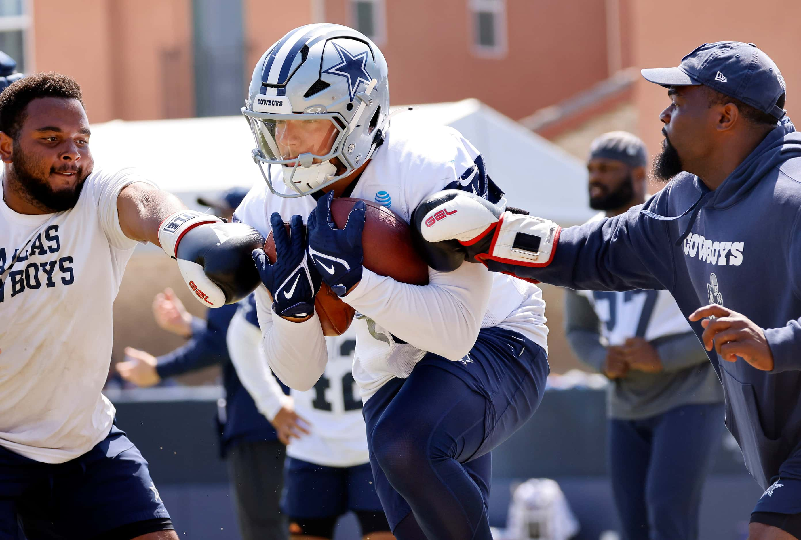 Dallas Cowboys running back Hunter Luepke (40) is pounded with boxing gloves during a...