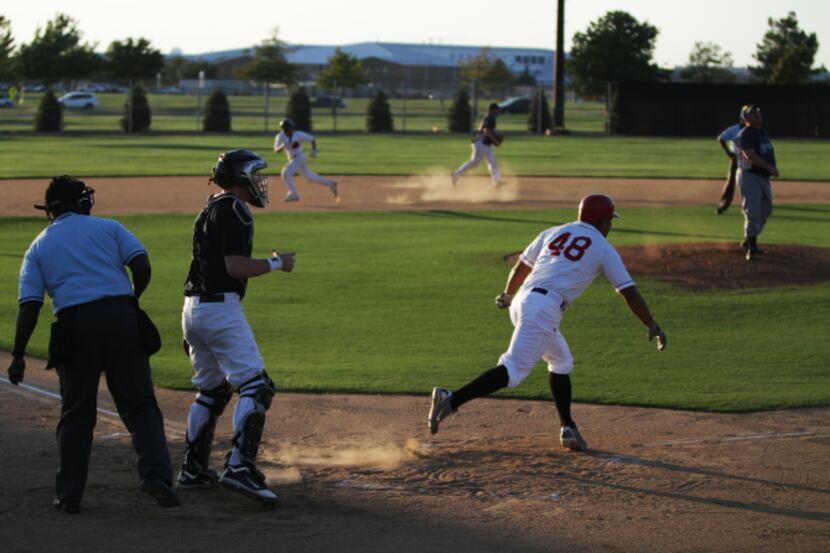 A batter on team Modoc runs to first after connecting on a pitch during a  game with the...