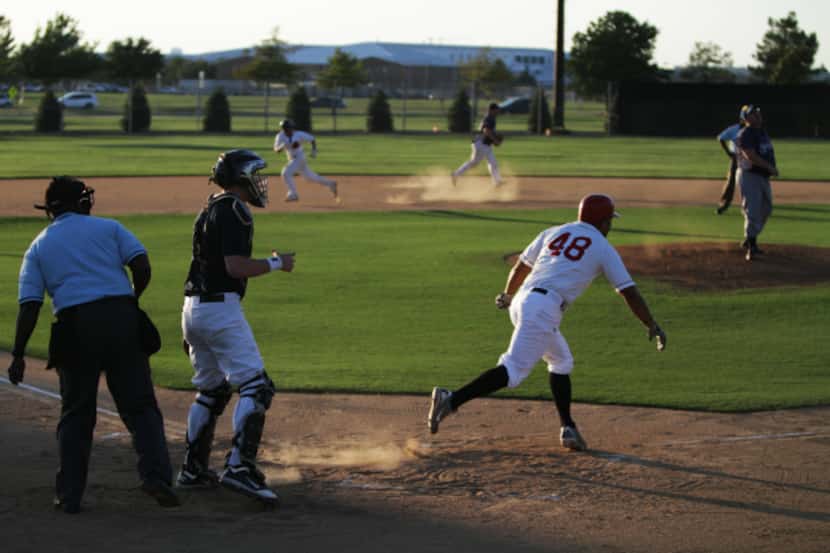 A batter on team Modoc runs to first after connecting on a pitch during a  game with the...