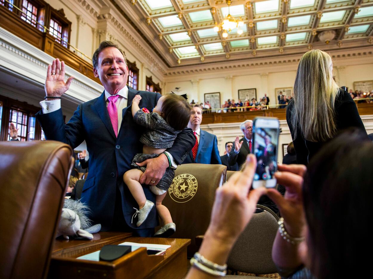 Texas State Rep. John Zerwas, R-Richmond, is sworn in while holding Tinley Zerwas, 1, during...