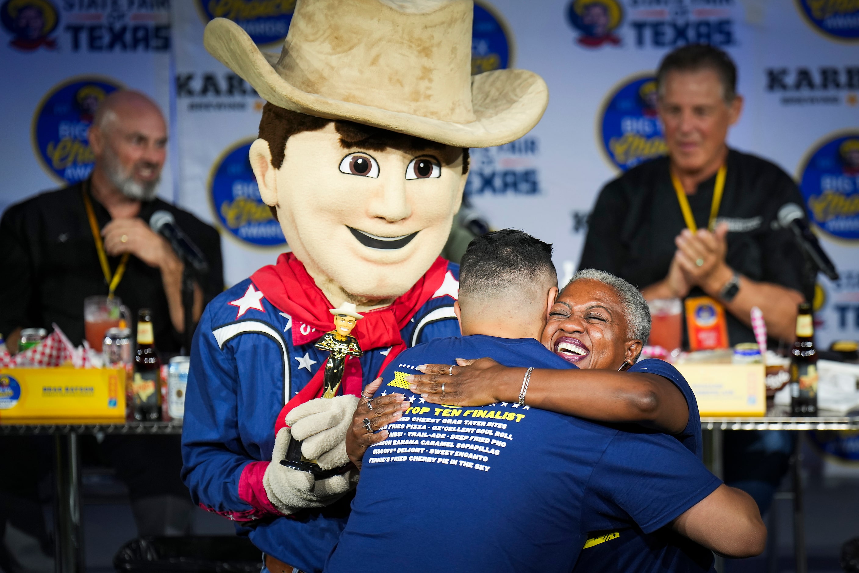 Melanie Linnear, senior vice president, concessions, congratulates Stephen El Gidi after he...