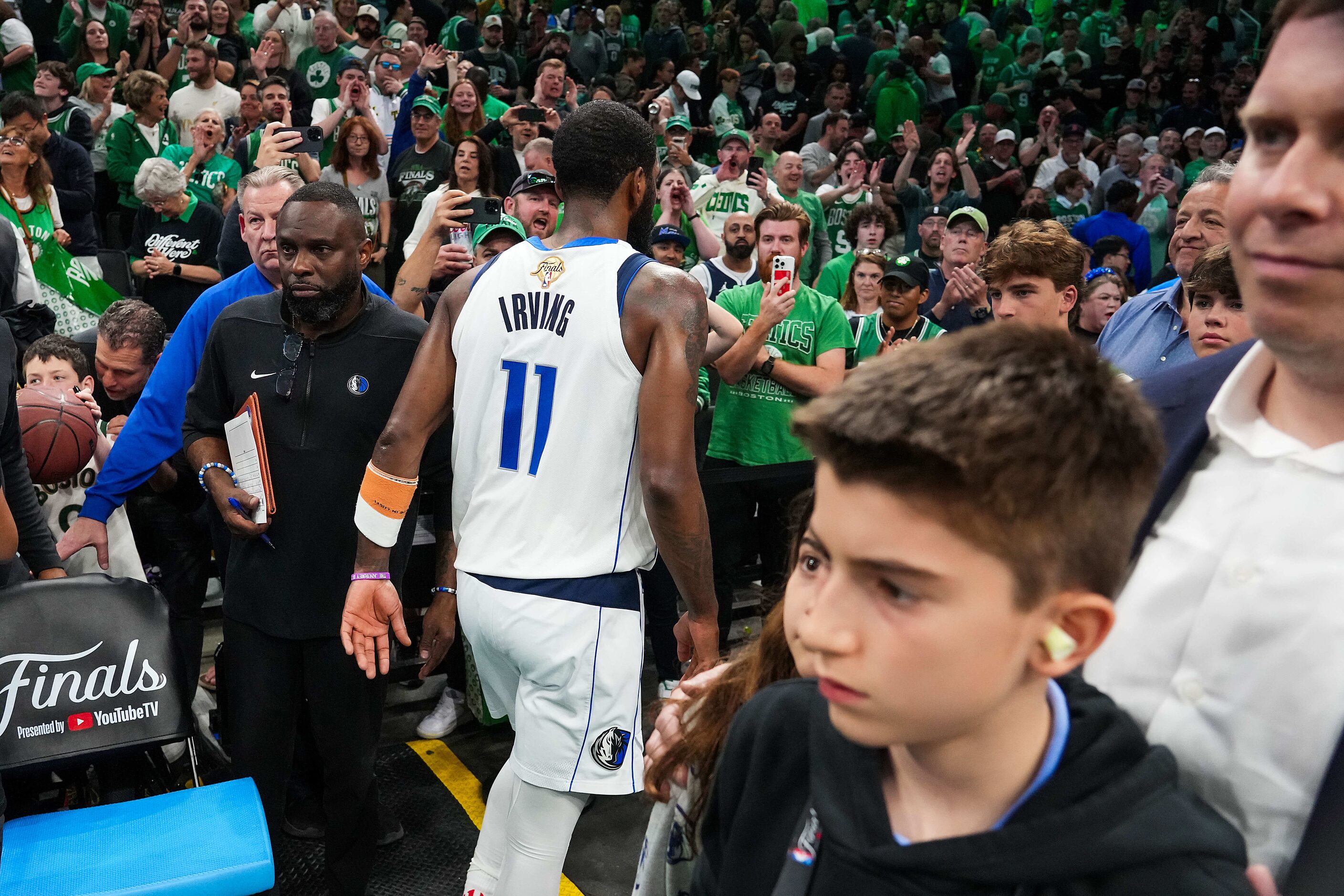 Dallas Mavericks guard Kyrie Irving (11) leaves the court past team governor Patrick Dumont...