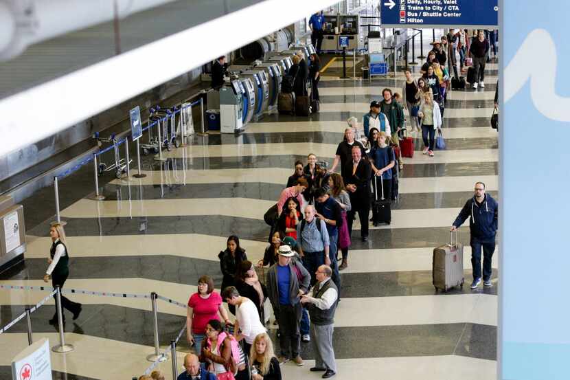  People wait in line to go through the TSA security checkpoint at Dallas Love Field in...