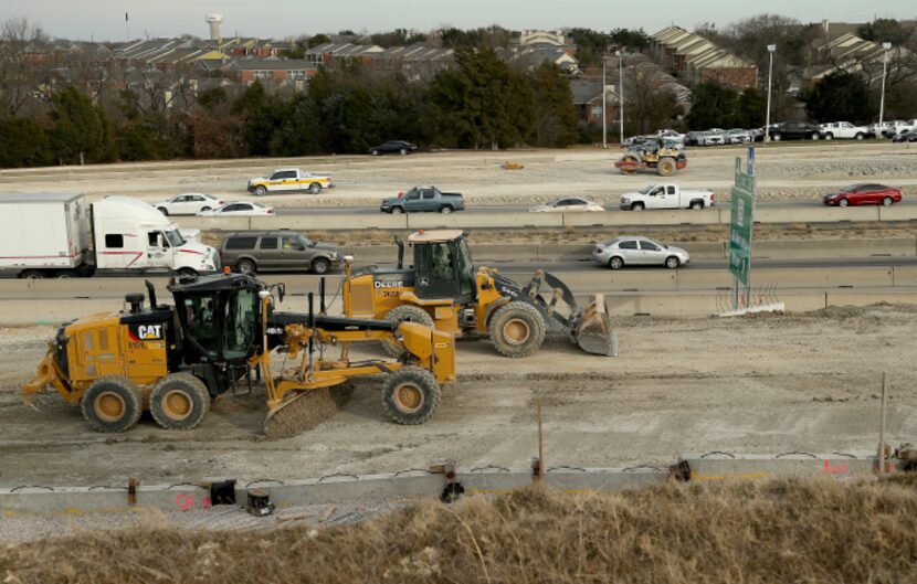 Heavy equipment, cars and trucks share the road on U.S. 75 in McKinney.