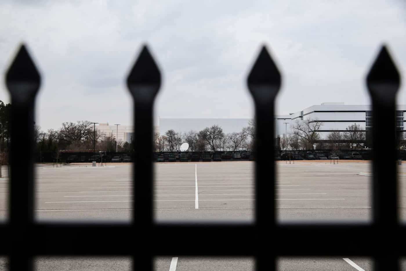 A locked fence and empty parking lot sat in the 2200 block of Burbank Street in Dallas on...