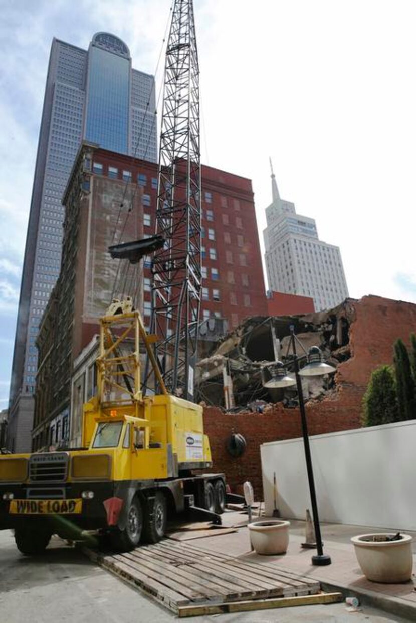 
Demolition crews continue tearing down early 20th century buildings on a square block...