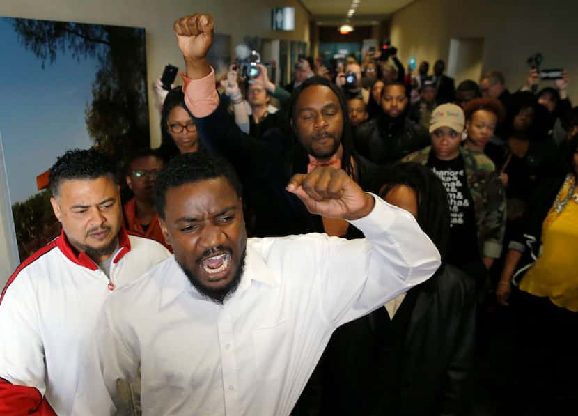 Dominique Alexander (center in white shirt) of Next Generation Action Network leads a...