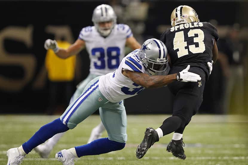 Dallas Cowboys cornerback Orlando Scandrick (32) makes a diving tackle on New Orleans Saints...