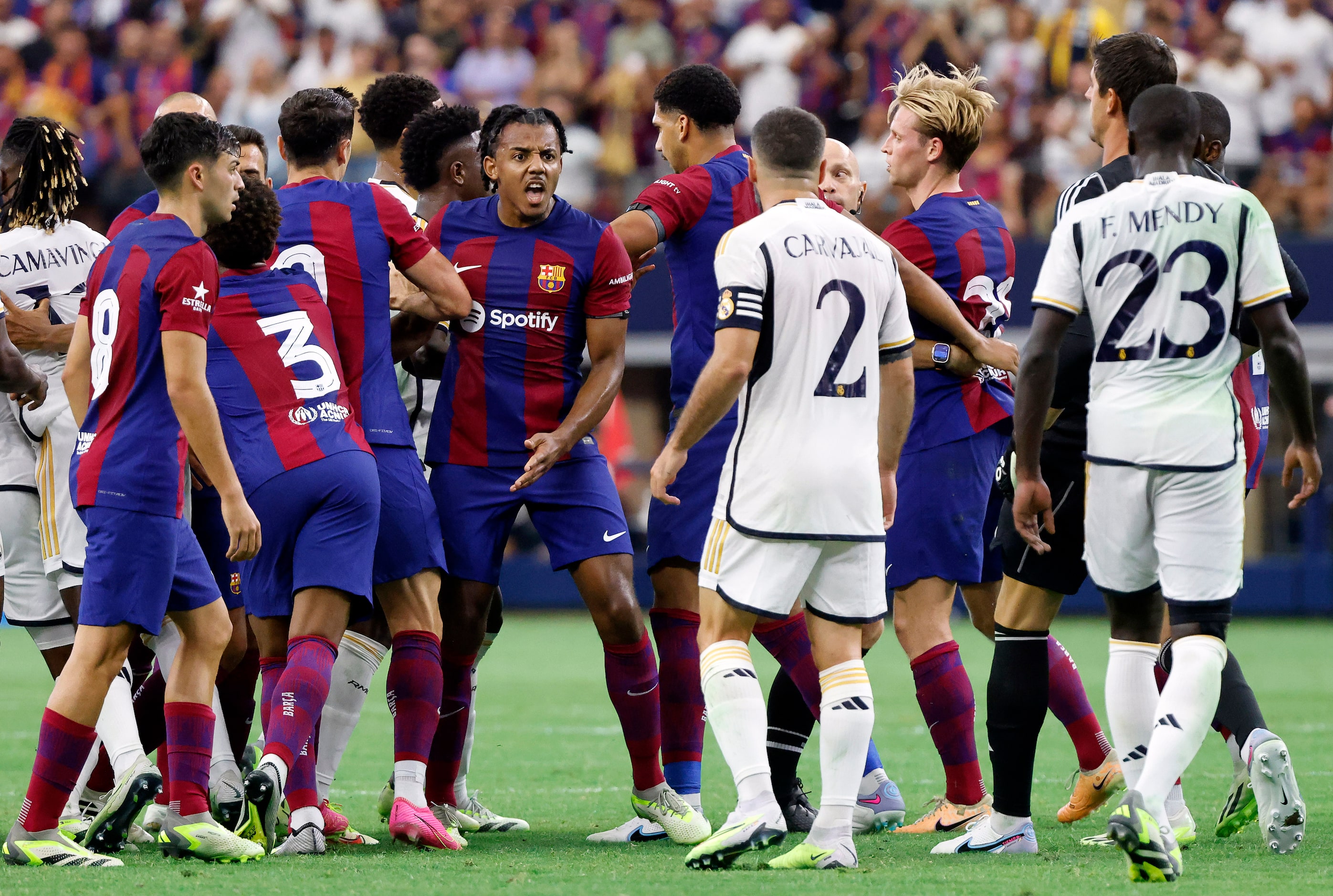 Tempers flared between Real Madrid and Barcelona players following a hit during the first...