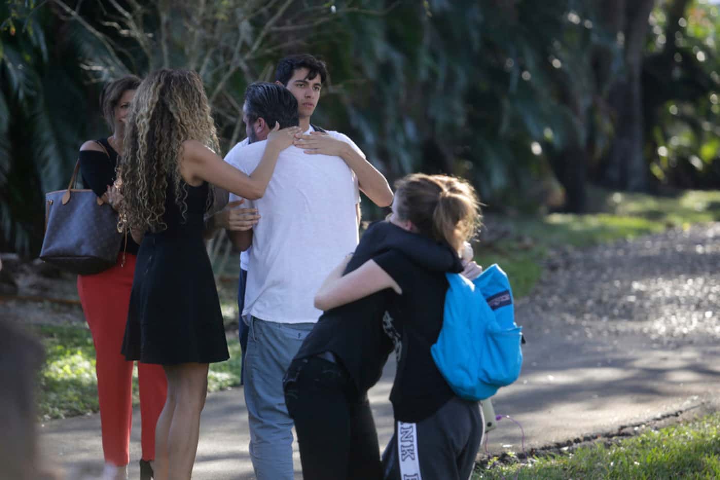Parents and students gather outside the Marjory Stoneman Douglas High School during a...