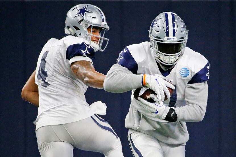 Dallas Cowboys quarterback Dak Prescott (4) hands off to  running back Ezekiel Elliott (21)...