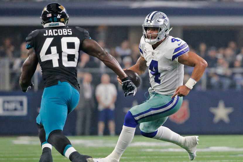 Dallas Cowboys quarterback Dak Prescott (4) runs as Jacksonville Jaguars linebacker Leon...