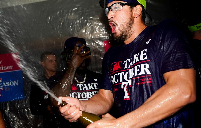 Texas Rangers starting pitcher Dane Dunning celebrates clinching a playoff spot in the...