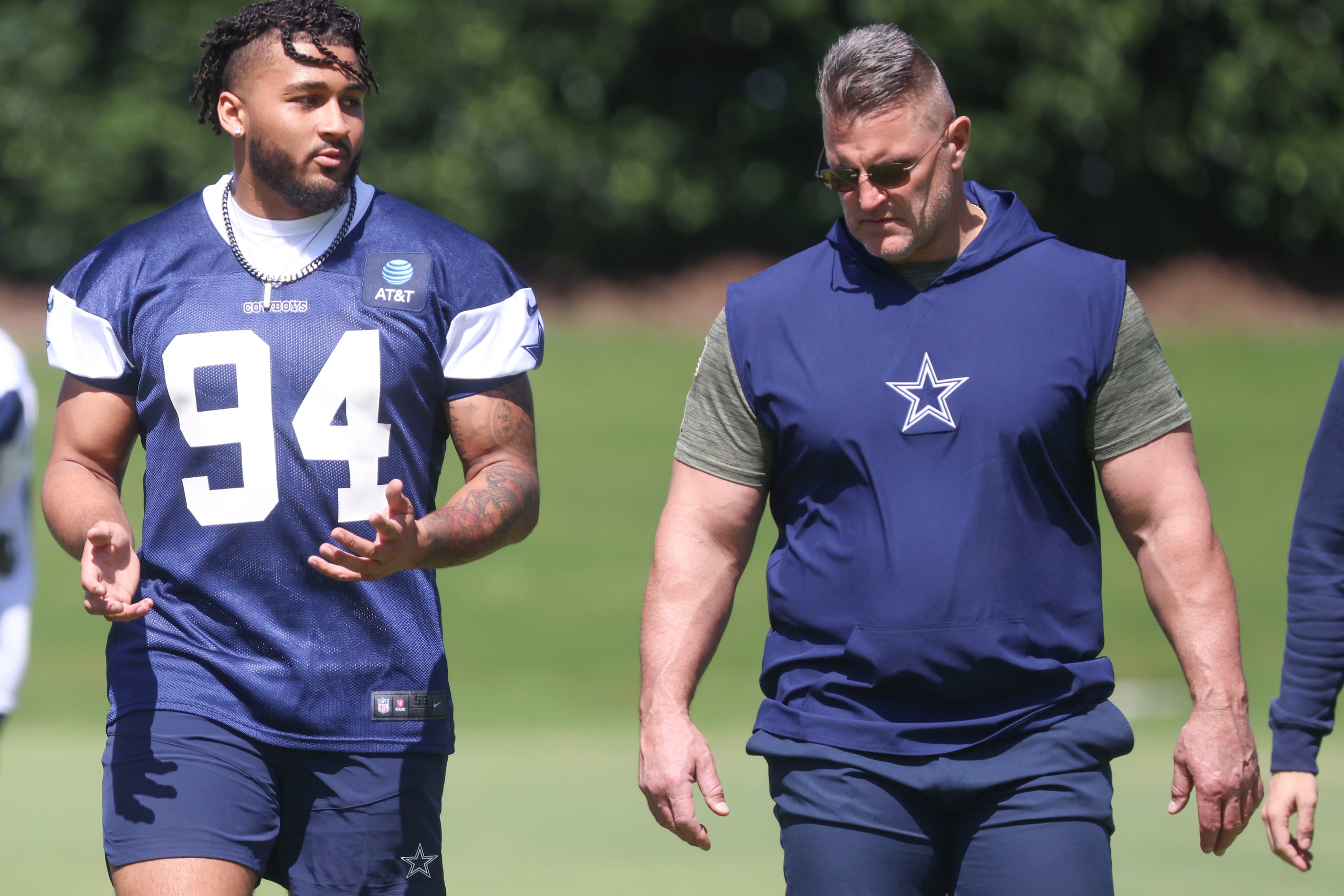 Dallas Cowboys defensive end Marshawn Kneeland (left) exits the field following a rookie...