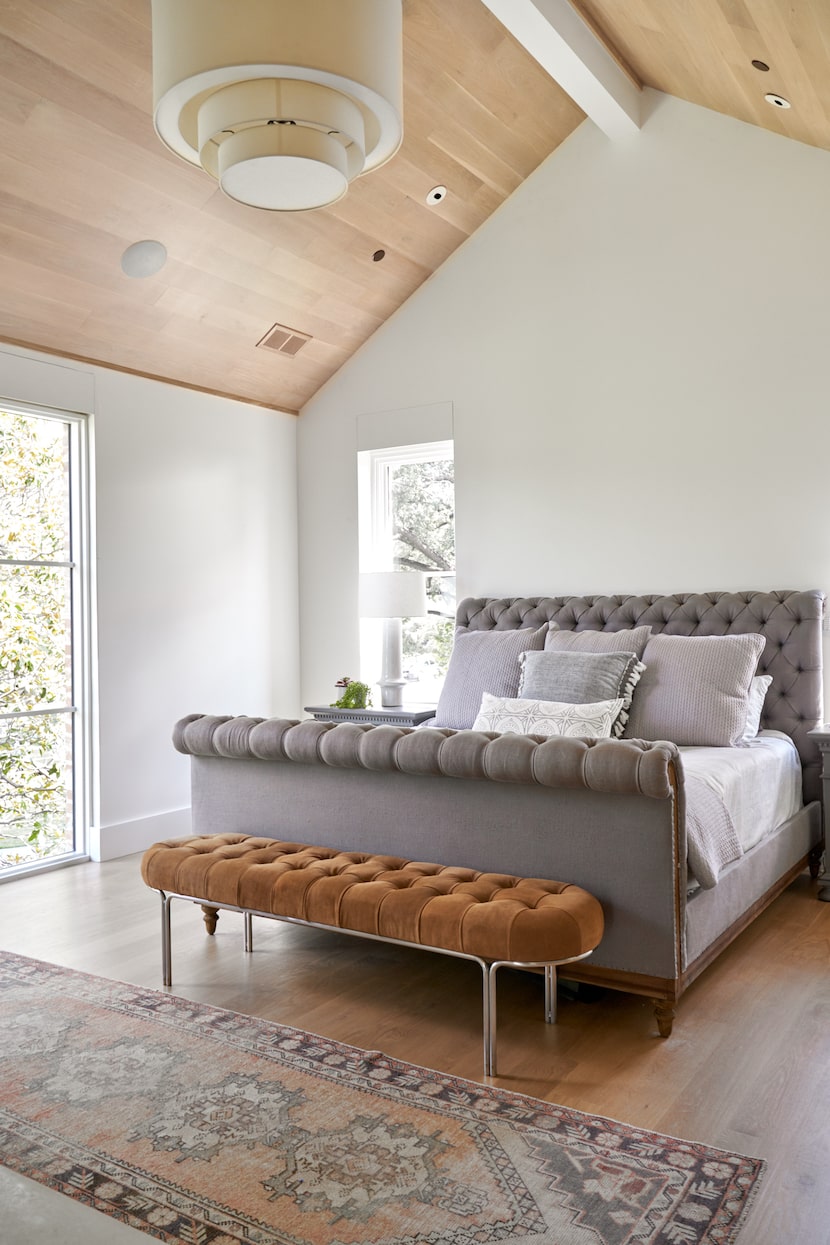 A bedroom has a wood ceiling.