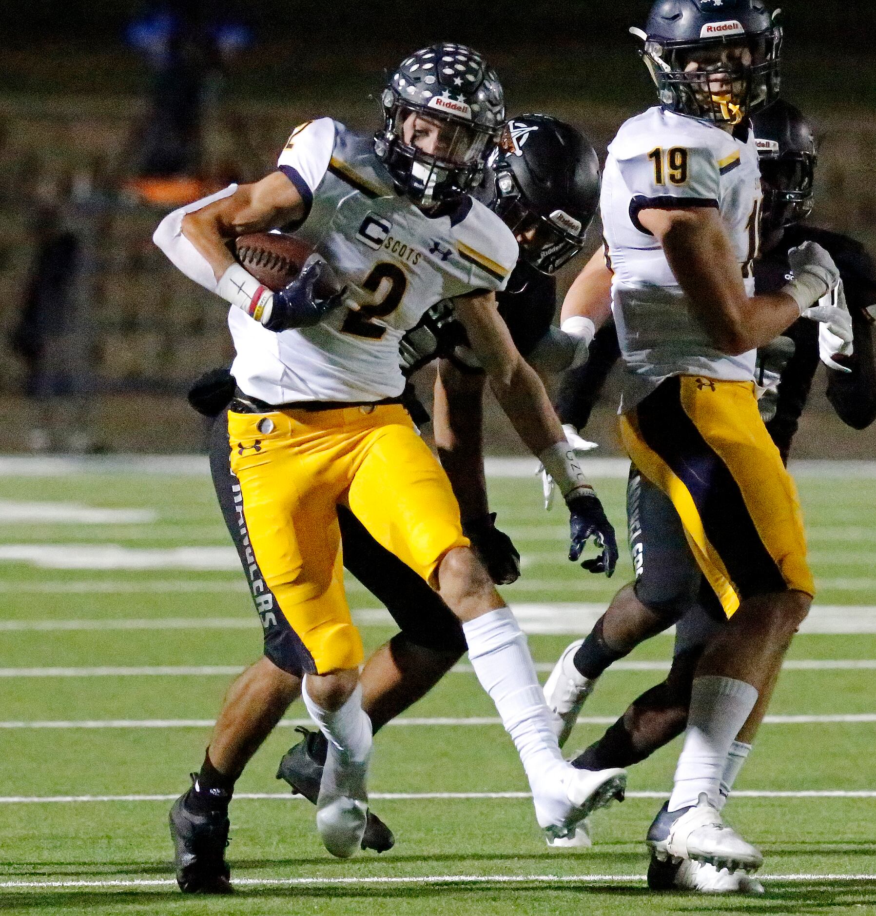Highland Park High School wide receiver John Rutledge (2) is tackled on a kickoff during the...