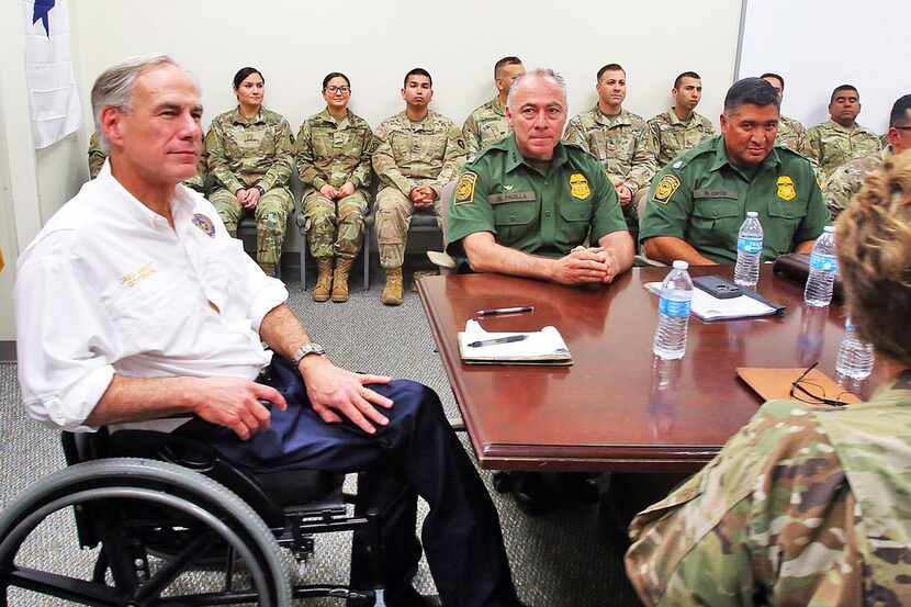Texas Gov. Greg Abbott (left) spoke with leaders of the Texas National Guard and the U.S....