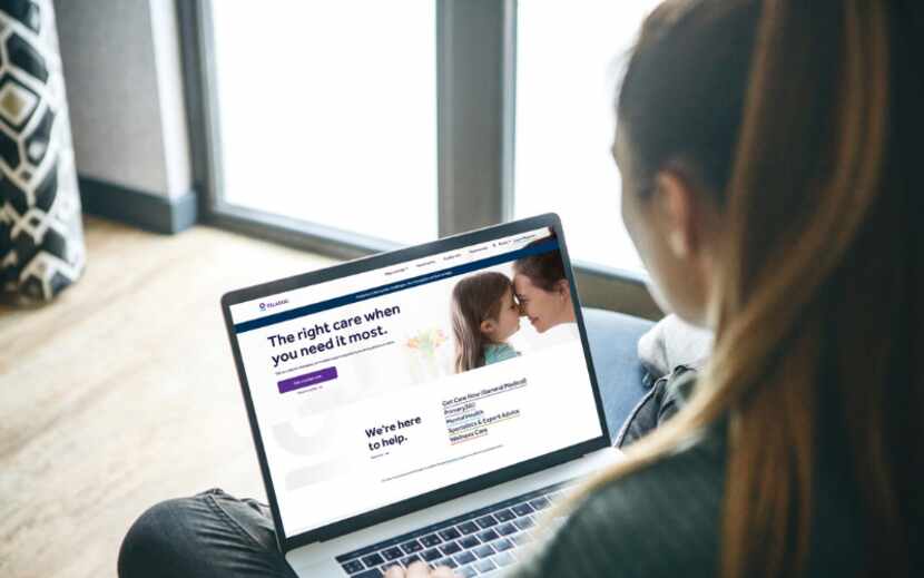 A woman with brown hair tied in a ponytail sits with a laptop, with Teladoc's website...