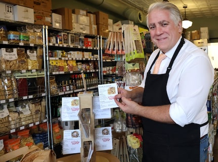 Ari Lowenstein, owner of Ari's Pantry, shows a display of recipe cards that guide customers...