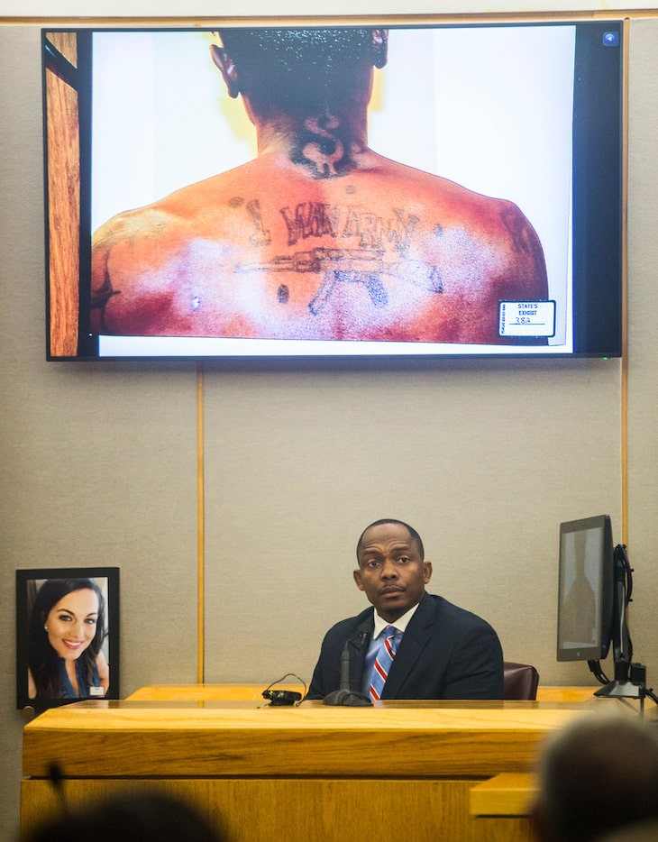 Dallas homicide detective Eric Barnes describes photos of Kristopher Love's tattoos during...