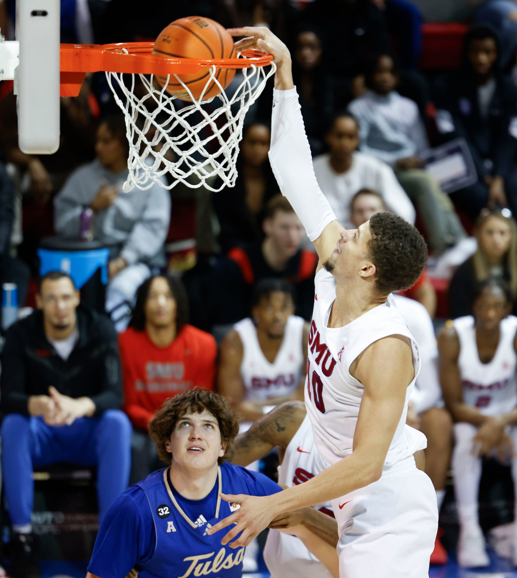 Southern Methodist forward Samuell Williamson slams asTulsa forward Matt Reed watches during...