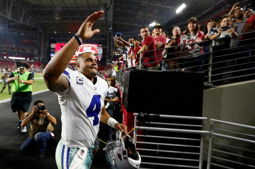Dallas Cowboys quarterback Dak Prescott (4) acknowledges the crowd as he exits the field...