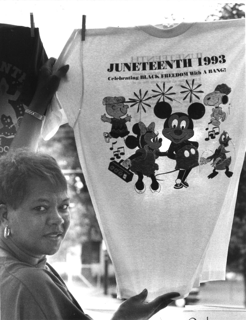 Pat Monroe, a Douglass Community Center volunteer, displayed a T-shirt offered for sale...