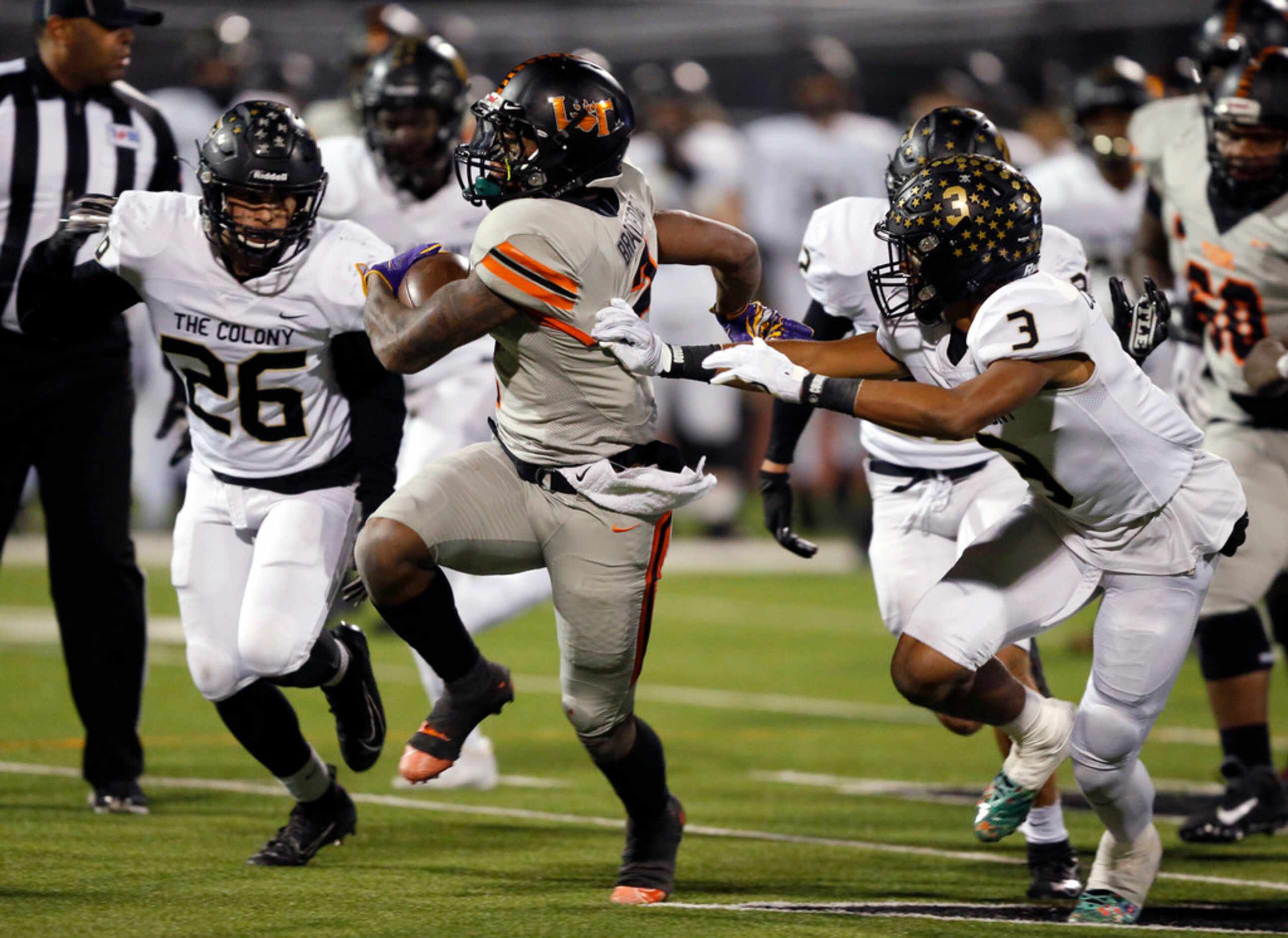 Lancaster running back Tre Bradford (2) breaks a tackle by The Colony's Christian Gonzalez...