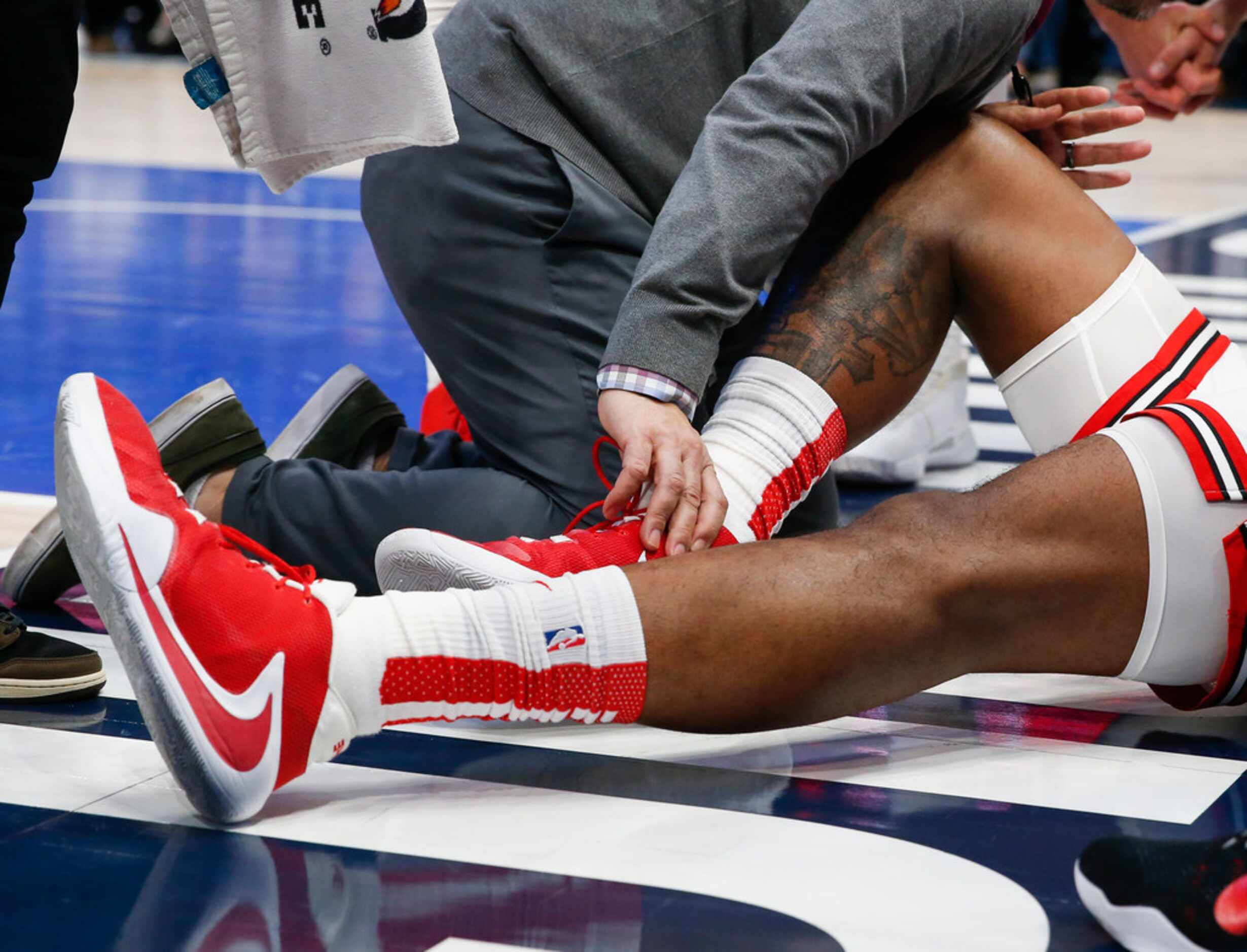 Trainers attend to Chicago Bulls center Wendell Carter Jr. (34) after being injured during...