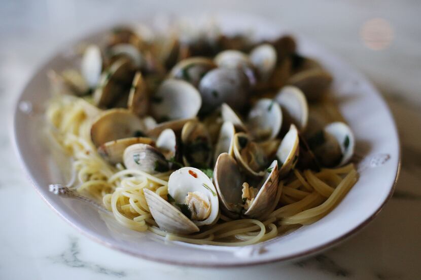 Clams over spaghetti is photographed in preparation of a traditional Italian Christmas...