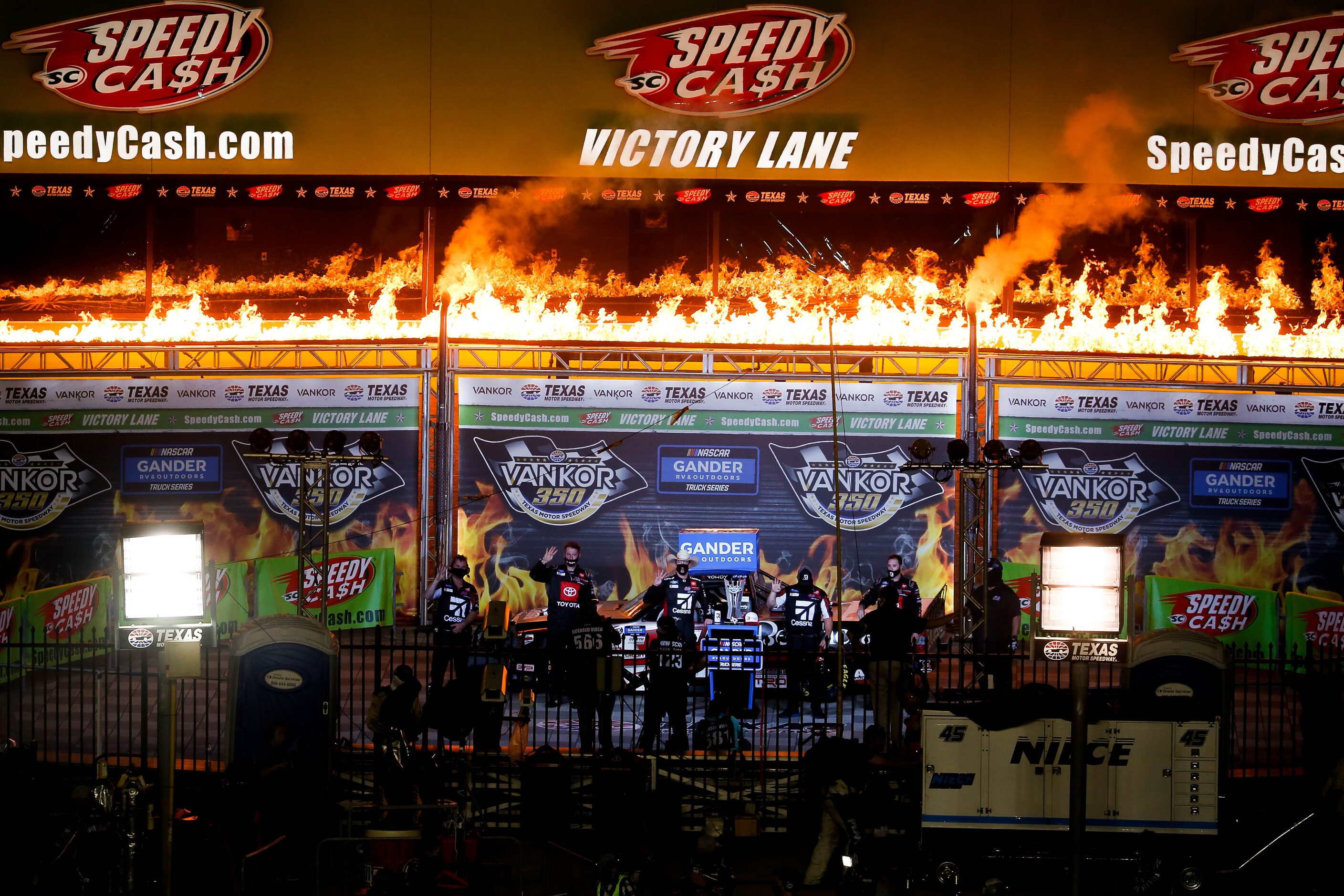 Driver Kyle Busch (No. 51)celebrates in Victory Lane after winning the Vankor 350 NASCAR...