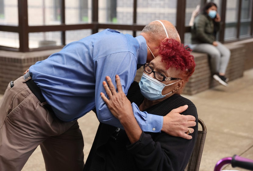 Dallas County District Attorney John Creuzot, left, hugs Lucille Spencer, mother of Ben...