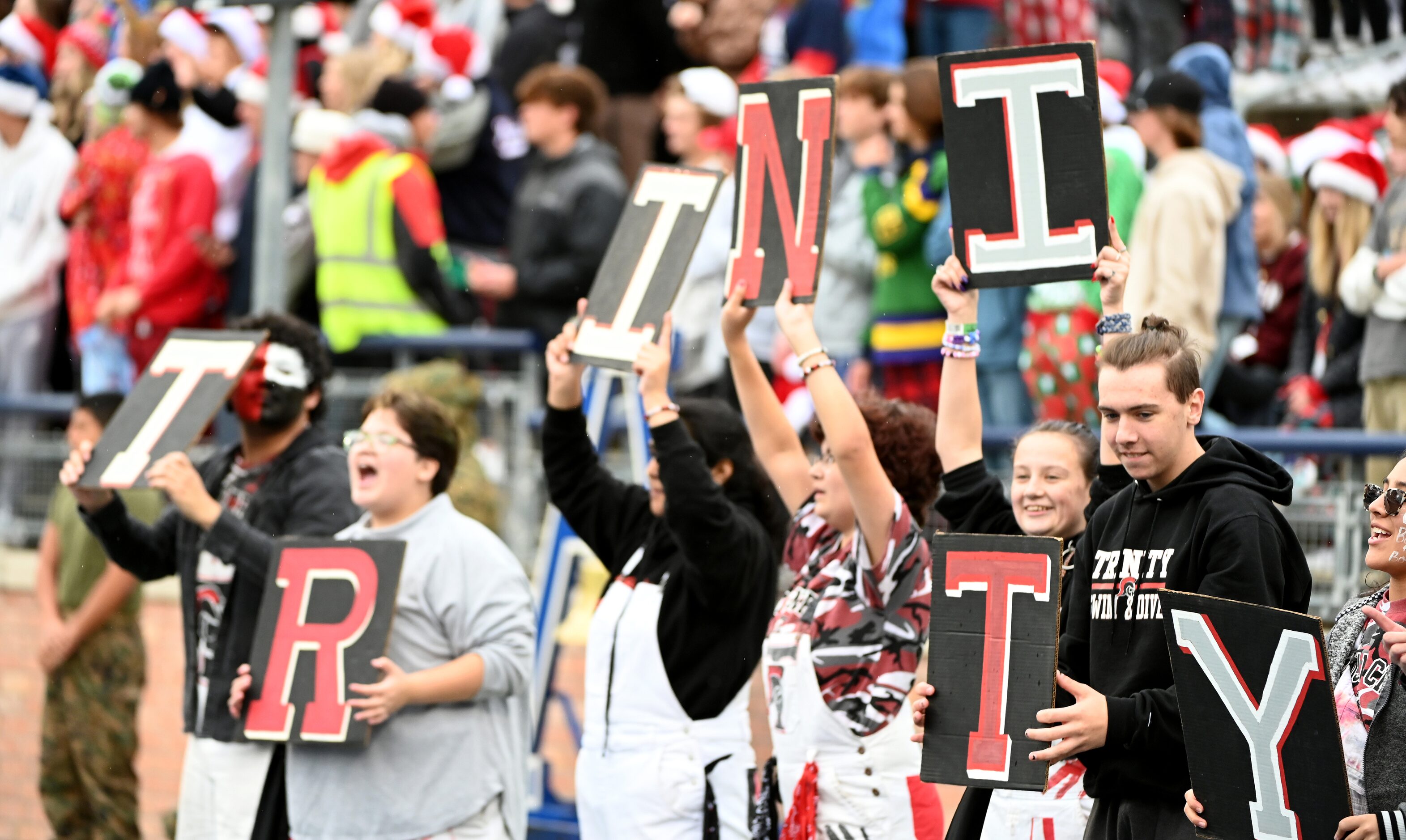 Members of the against the Euless Trinity Trojan Crew cheer in the first half of Class 6A...