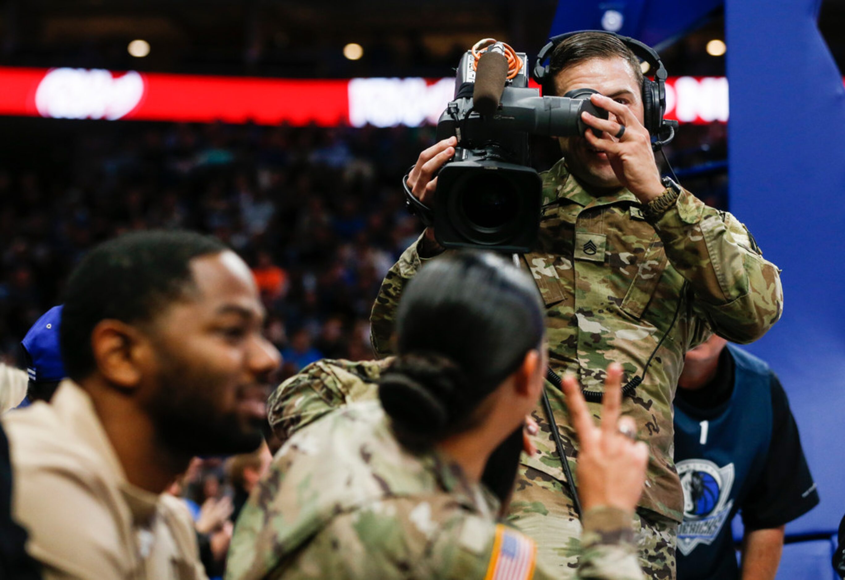 A member of the armed forces tries his hand at running a video camera as veterans and...