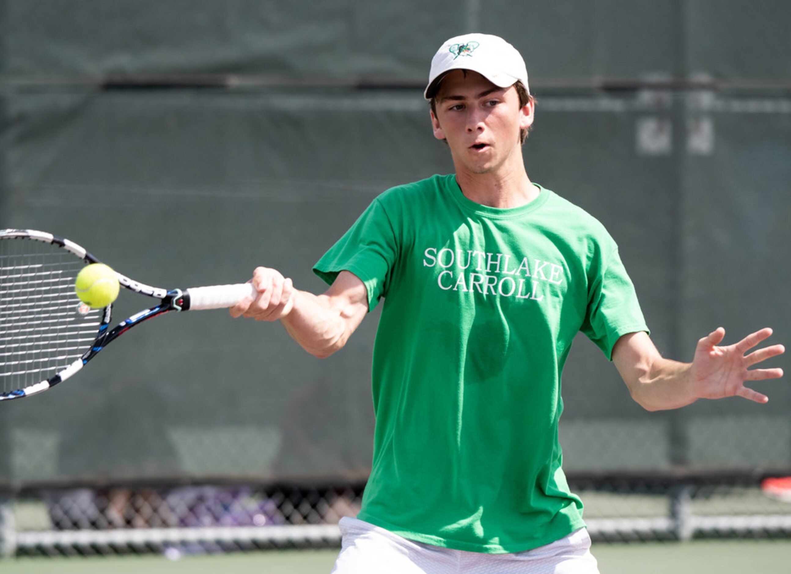 Southlake Carroll's Ryan Schmuhl returns the ball in a doubles match with teammate Inesh...