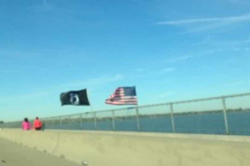  A two-flag Veterans Day display over Lake Ray Hubbard flies in the face of Texas Department...