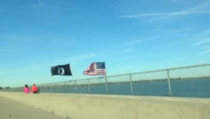  A two-flag Veterans Day display over Lake Ray Hubbard flies in the face of Texas Department...