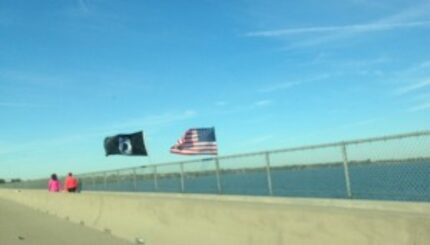  A two-flag Veterans Day display over Lake Ray Hubbard flies in the face of Texas Department...