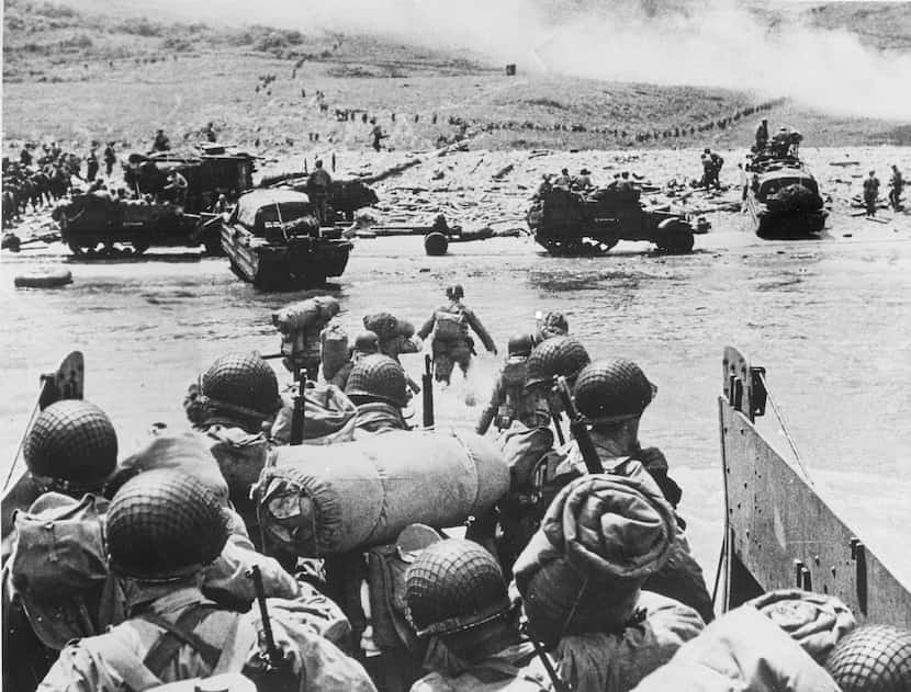 American soldiers and supplies arrive on the shore of the French coast of German-occupied...