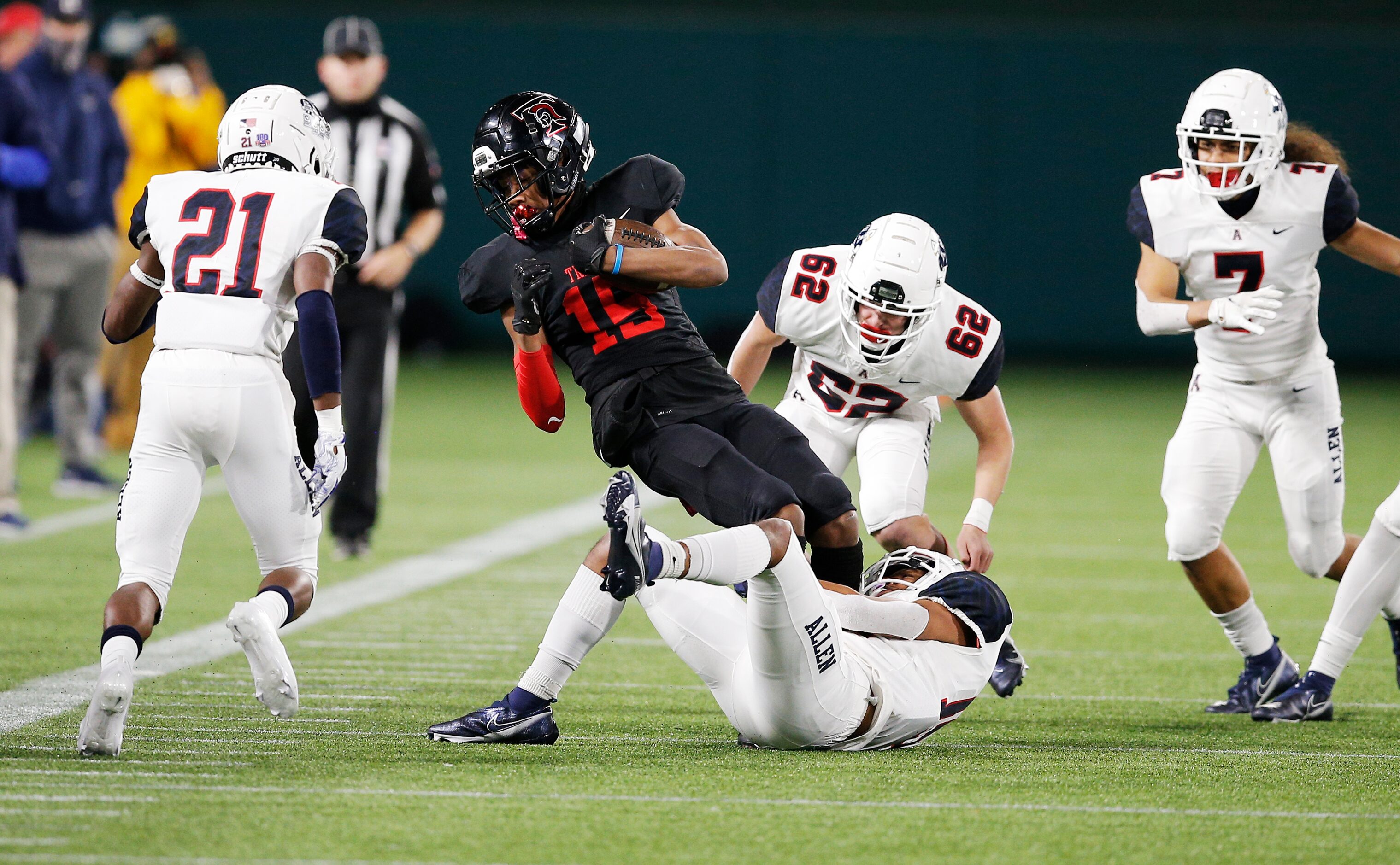 Euless Trinity junior wide receiver Pofele Ashlock (15) is tackled by Allen senior defensive...