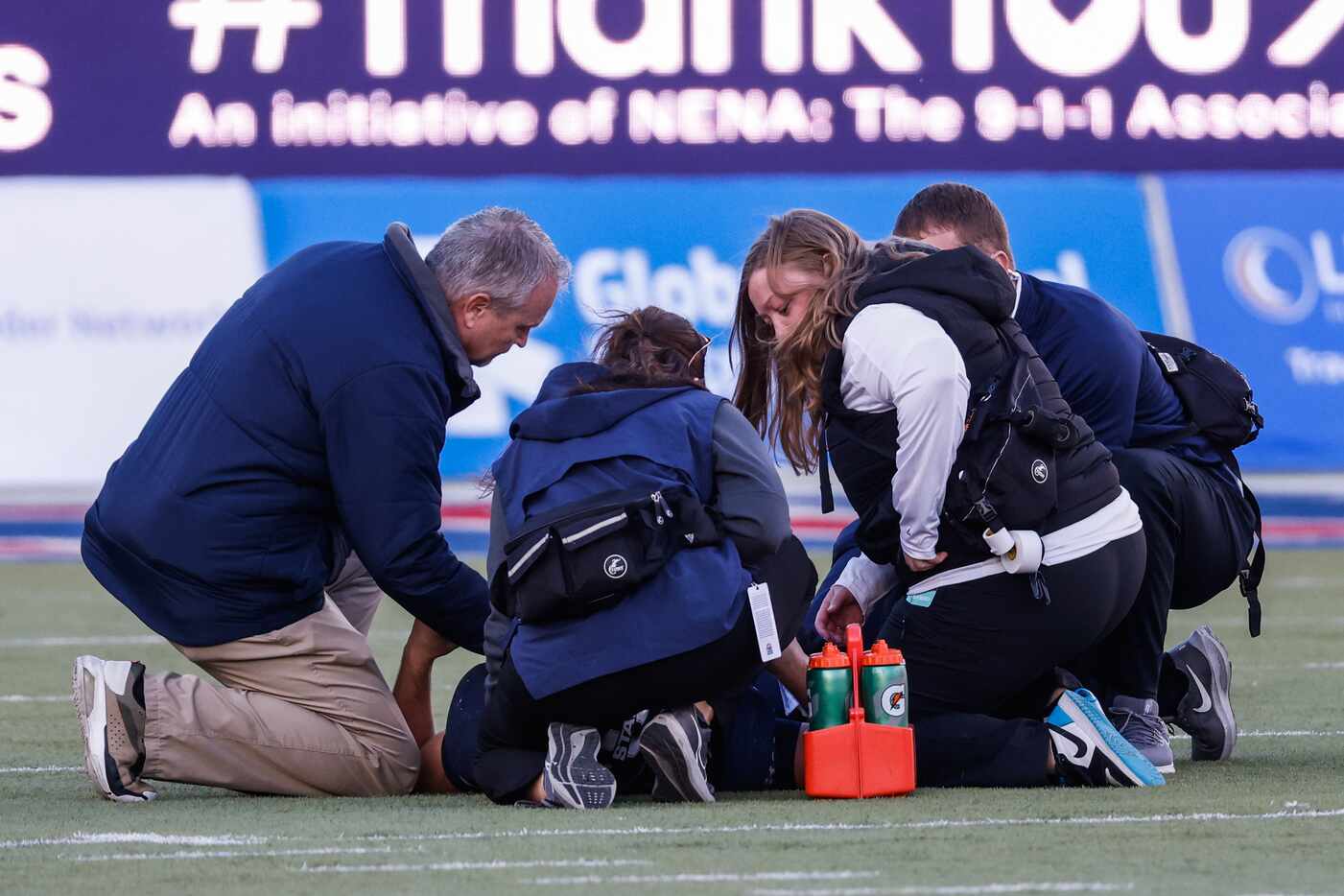 Utah State Aggies quarterback Cooper Legas (5) attended by medical staff after being sacked...