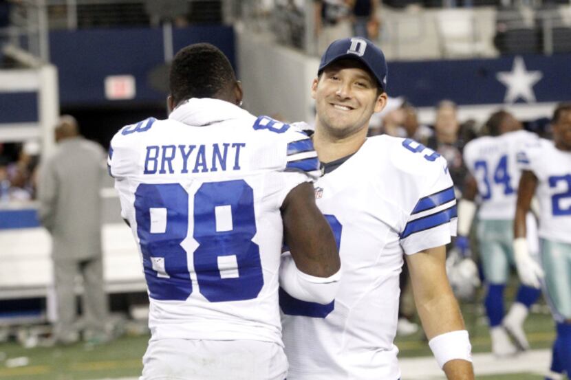 Dallas Cowboys wide receiver Dez Bryant (88) and quarterback Tony Romo (9) celebrate their...