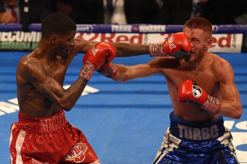 Maurice Hooker (left) lands a punch against Brit Terry Flanagan during their contest for the...
