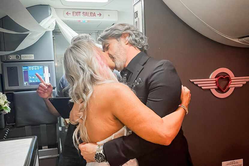 Pam Patterson and Jeremy Salda kiss after being married aboard Southwest Airlines flight...
