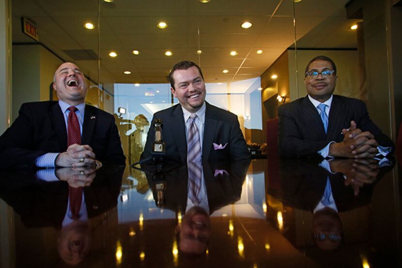 Lawyers Peter Schulte (left) and Kevin Brooks laugh along with their client Judge Carlos...