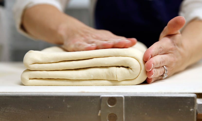 Andrea Meyer, executive pastry chef and owner of Bisous Bisous Patisserie folds the dough...